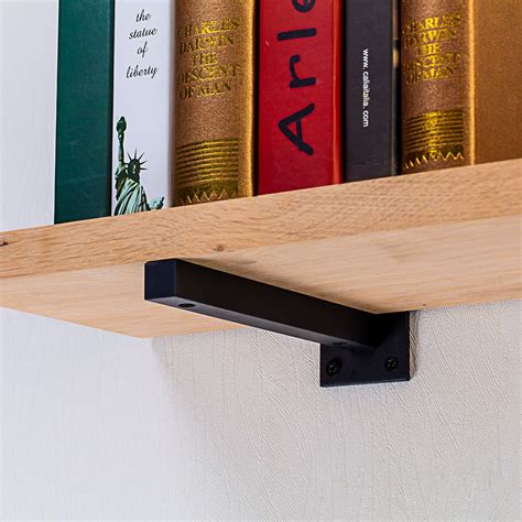 a creative bookshelf one metal bracket holding books|hanging shelf brackets diy.